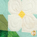 A super close up on the center of the strawberry flower, showing fabric and top stitching details.