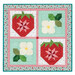 The completed Pieceful Patchwork - June wall hanging, a design of two red strawberries and two white strawberry flowers colored in teal, white, red, and green fabrics, isolated on a white background.