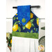 A shot of the top section of the towel taken from a slight angle, showing details on the lemon fabrics as well as the fabric button.