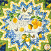 A top down view of the center of the topper, demonstrating details on the focus fabric, a white print with various summer and lemon motifs like butterflies, lemons, and text about lemons.