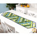 The completed Greased Lightning Table Runner in green, blue, and yellow fabrics from the Limoncello collection, staged on a white table.