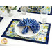 A shot of a place setting with the coordinating cloth napkins and tableware set on the placemat, showing function.