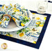 A close up shot of a place setting with the coordinating cloth napkins and tableware set on the placemat, showing function.