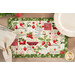 A top-down shot of the placemat, set with a white ornate plate and cloth napkin on a wood table.