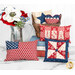 A collection of red, white, and blue decorative pillows in various patterns next to a floral arrangement.