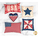 Five decorative pillows in red, white, and blue patterns, including stars and stripes, on a marble surface.
