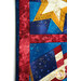 A shot of the left side of the project, demonstrating fabric, border, sashing, and binding details.