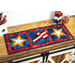 A shot of the project as a table runner, displayed horizontally on a wooden table set with coordinating patriotic candles and decor.