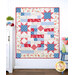 The Comfort of Psalms Quilt - Hollyhocks & Roses in red, blue, and cream, displayed against a light wall next to surrounding decor