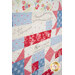 A quilt featuring a mix of floral and checkered patterns with inspirational text in elegant script.