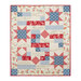 A quilt featuring red, blue, and cream stars with floral patterns and biblical scripts isolated on a white background.