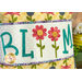 A super close up on the appliqué letters and flowers, showing fabric and button details.