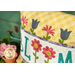 A stylized shot of the pillow next to a coordinating vintage suitcase.