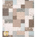 A quilt featuring a patchwork design of light blue, beige, and brown fabric squares with nature patterns.