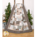 The Easy as ABC and 123 Quilt - Forest Tales quilt featuring a patchwork design in neutral tones hanging from a wooden ladder next to green trees and coordinating decor.