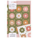 The front of the Vintage Blooms pattern, featuring the completed quilt on a light pink background and a closeup on the corner of the design.