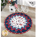 The Stars and Stripes Forever table topper with a star pattern, featuring red, white, and blue designs on a wooden table next to coordinating decor.