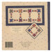 The back of the pattern with the finished runner and pillow on a fabric background.