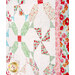 An angled shot of the right side of the quilt, demonstrating fabric, piecing, and border details.