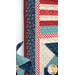 A close up on the borders of the project; a coordinating spinning pinwheel peeks into frame.