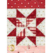 Close-up of a quilt featuring a red and cream star pattern, accented with floral and dotted fabrics.