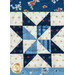 Close-up of a quilt featuring a blue and cream star pattern, accented with floral and dotted fabrics.