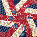 A super close up on the center of the topper, showing print details on all the fabrics where they meet in the center.