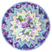 A circular table topper mat featuring a vibrant floral pattern with purple and aqua hues and a starburst design isolated on a white background. 
