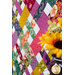 A close up on the quilt, demonstrating the vibrant fabrics and woven effect of the patchwork.