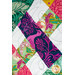 A close up on the quilt, demonstrating the vibrant fabrics and woven effect of the patchwork.