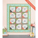 The completed Forever Sisters Charm Quilt colored in vibrant aqua, green, charcoal, and pink fabrics from the Abloom collection, hung on a cream paneled wall above a gray armoire, staged with coordinating decor.