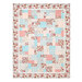 A quilt featuring a patchwork of floral, checkered, and polka dot patterns in pink and blue, isolated on a white background.