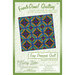 Front of the Easy Diamonds Quilt pattern featuring a quilt with colorful geometric designs.