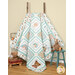 A shot of the quilt artfully draped over a wooden ladder and fanned out amongst stuffed animal toys.