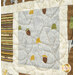 A super close up shot of the window with acorns and blowing leaves, with a leaf design stitching on top of the fabric.