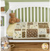 A shot of the finished Views quilt staged on a crib with the front removed, showing how it would sit inside. A teddy bear sits inside the crib for scale.
