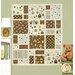 The Views quilt, featuring various woodland fabrics in brown, light blue, and gray, displayed against a green paneled wall.