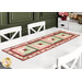 The completed table runner made with log cabin blocks of red, pink, cream, and green floral fabrics from the Regal Rose collection, laying in the center of a white dining table with white chairs.