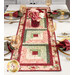 A shot of the table runner set with coordinating decor, glasses, place settings, cloth napkins, and flowers.