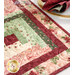 A close up on the corner of the table runner, demonstrating fabric, log cabin blocks, piecing, binding, border, and stitching details.