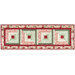 The completed table runner made with log cabin blocks of red, pink, cream, and green floral fabrics from the Regal Rose collection, isolated on a white background.