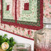 An angled shot of the bottom of the wall hanging with glass bottled peeking into frame from the bottom right corner.