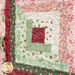 An angled shot of one of the log cabin blocks, demonstrating fabric, piecing, and stitching details.