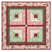 The completed Log Cabin Wall Hanging colored in the pink, red, and green floral fabrics of the Regal Rose collection, isolated on a white background.