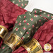 A close up on the red and green rose fabrics, demonstrating fabric and stitching details.