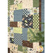 A close up of a patchwork quilt with outdoorsy motifs in natural tones of green, blue, and brown.