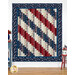 A patriotic diagonal striped quilt in red, white, and blue, displayed on a wall.