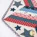 A super close up on a corner of the topper, showing details on the appliqué stars around the border.