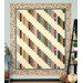 The finished 28th Floor Quilt colored in the cream, pink, teal, brown, black, and green fabrics from the Collections for a Cause: Unity collection, hung on a blue-paneled wall with coordinating furniture and decor framing the quilt on either side.