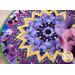 A stylized close up on the topper, showcasing fabric patterns, colors, and details; coordinating decorative flowers peek into frame from the right side.